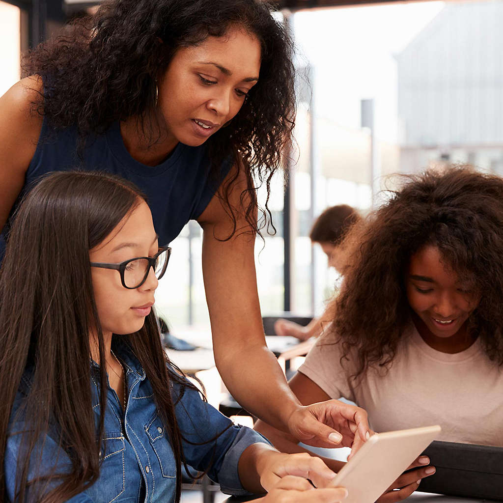 Teacher working with teenage students