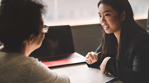 Active senior woman having discussion with agent about her retirement investment plan