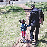 father and daughter leave the house holding hands