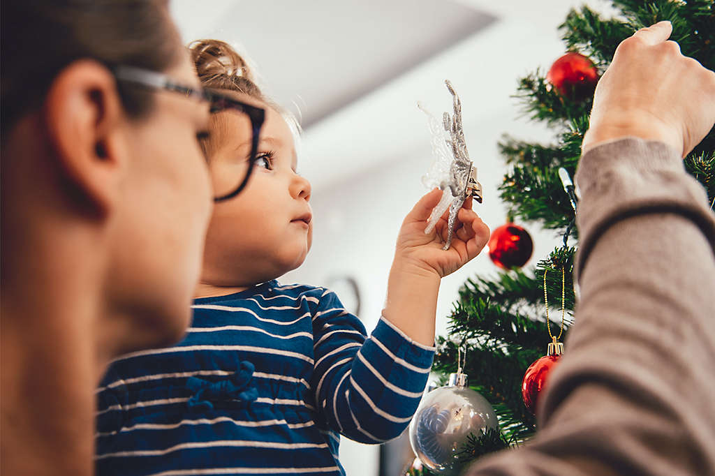 Family decorating a tree