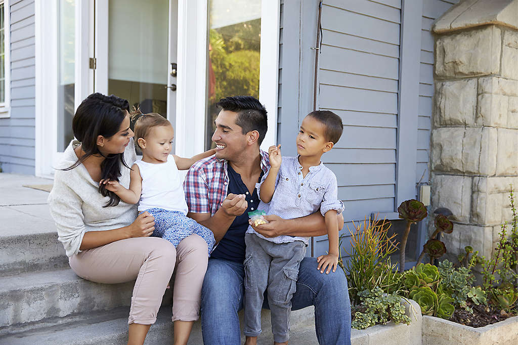 Family sitting on porch steps