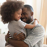 Father hugging young daughter