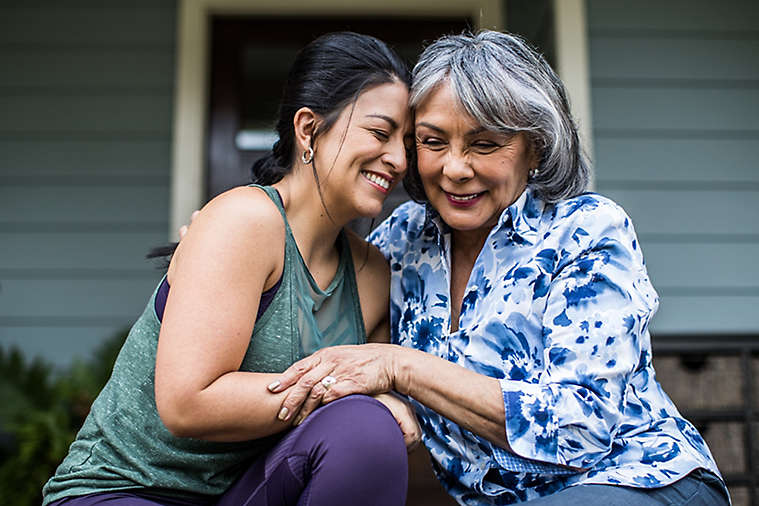 Mother and Daughter hugging on porch