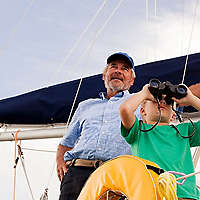 Grandfather teaching his grandchild about sailing
