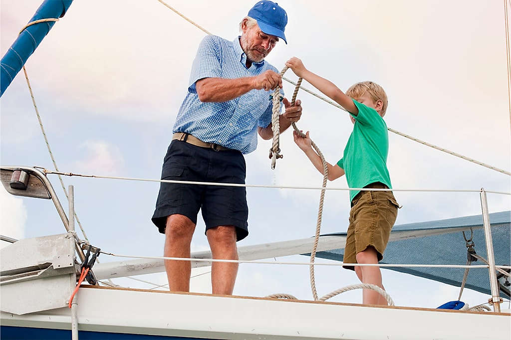 Grandfather and Grandson anchoring a boat