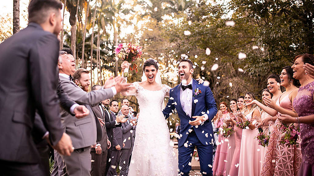 Married couple walking down aisle