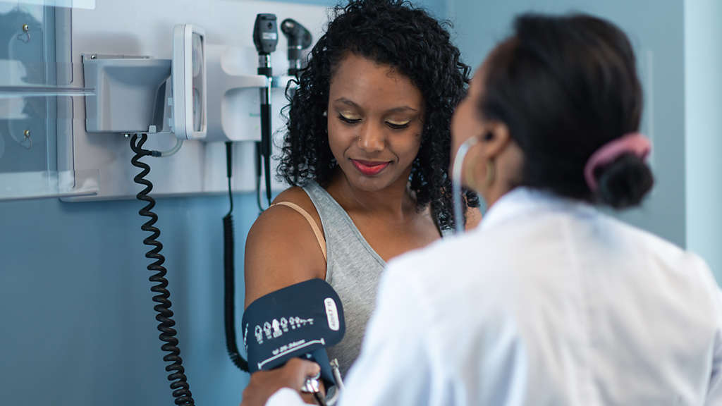 Woman getting a life insurance medical examination