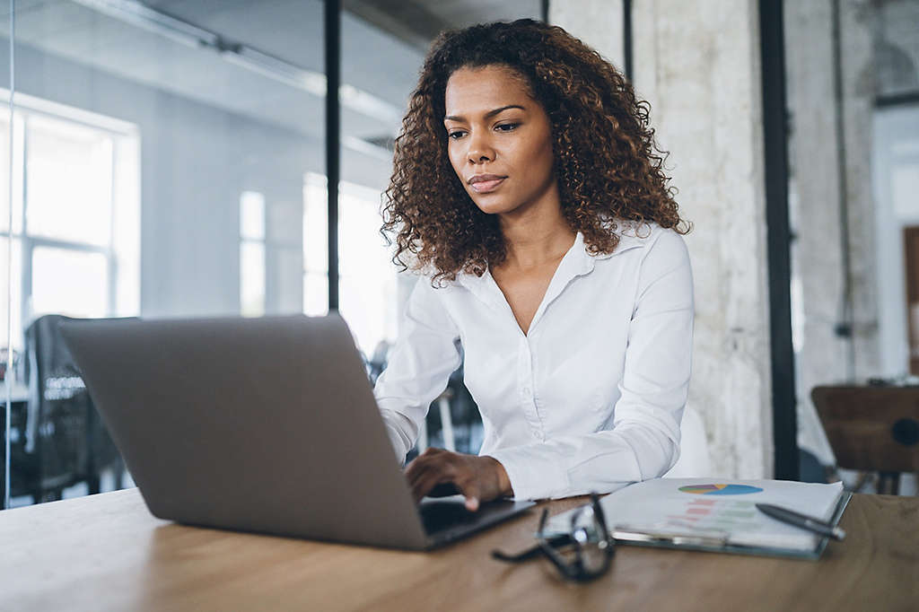 African american business woman working at the office using laptop.