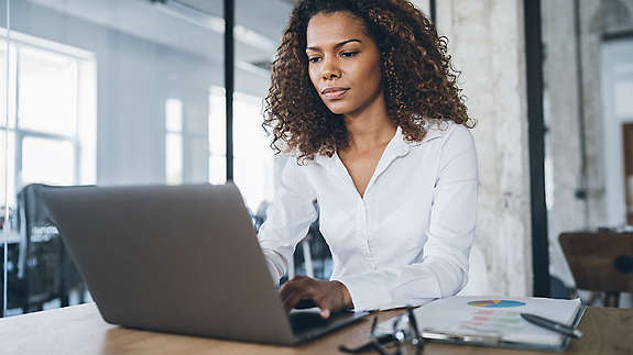 African american business woman working at the office using laptop.