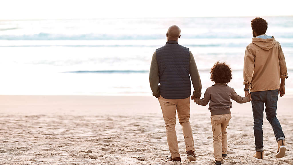 Three generations of a family together on the beach