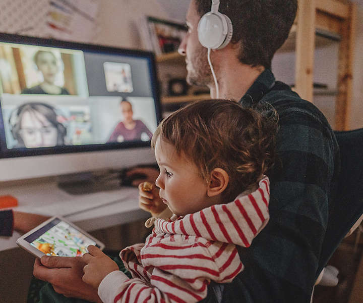 Man on work video conference with children