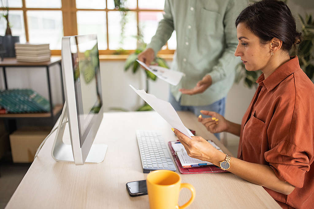 Businessman and businesswoman working together on project in modern office