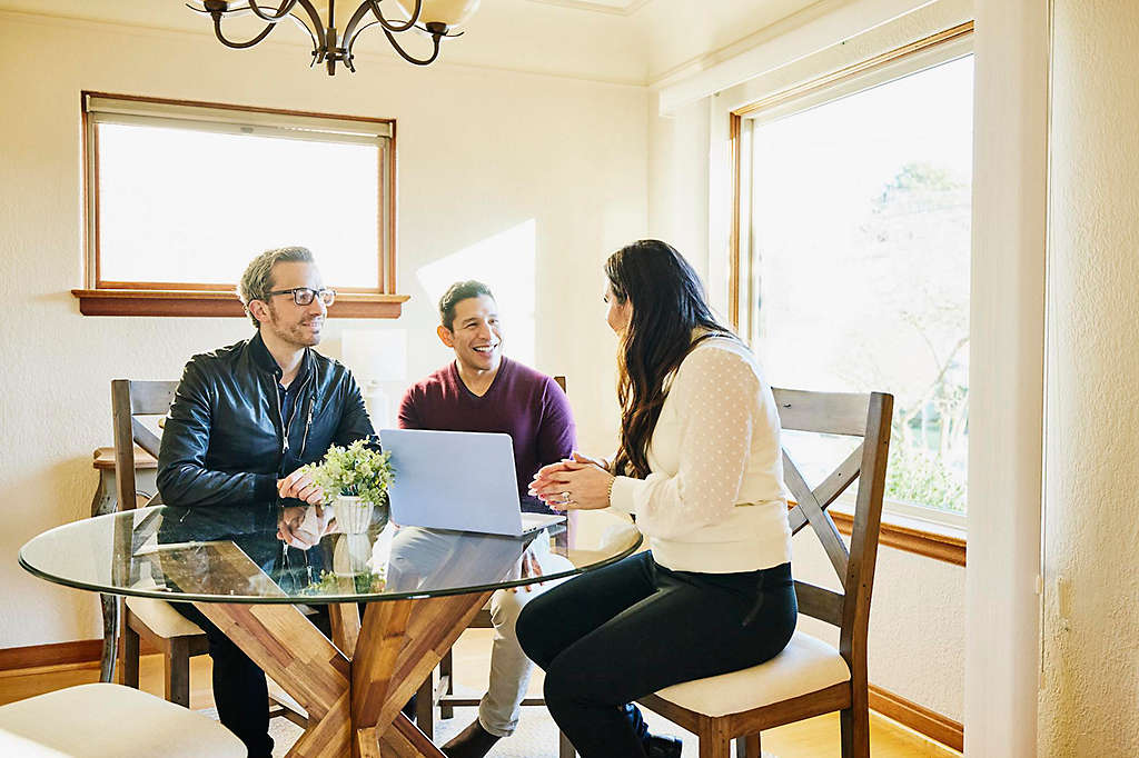 A couple discussing retirement planning with their agent