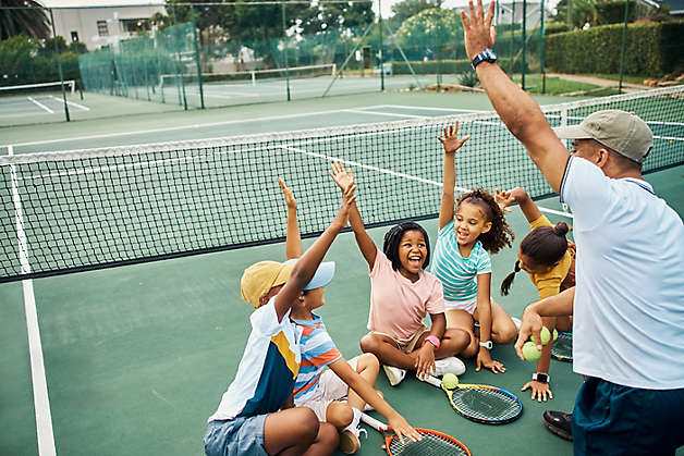  Excited, hands up and tennis lesson for kids on court outside