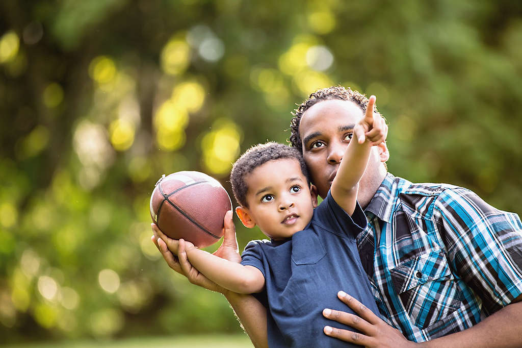 Father and son playing football