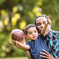 Father and son playing football