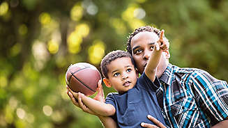 Father and son playing football