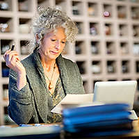 Woman researching online on a laptop comparing different types of trust options