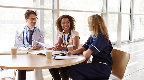  Senior healthcare workers in consultation in a meeting room