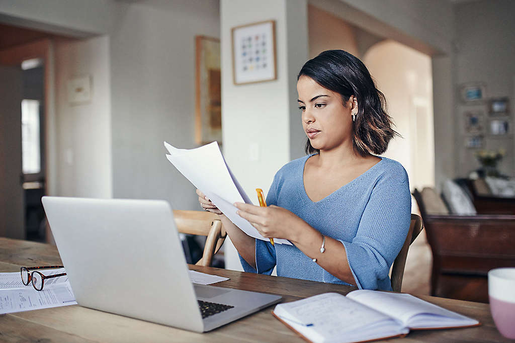 Woman sitting at her desk reviewing term life insurance policy options