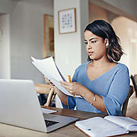 Woman sitting at her desk reviewing term life insurance policy options 