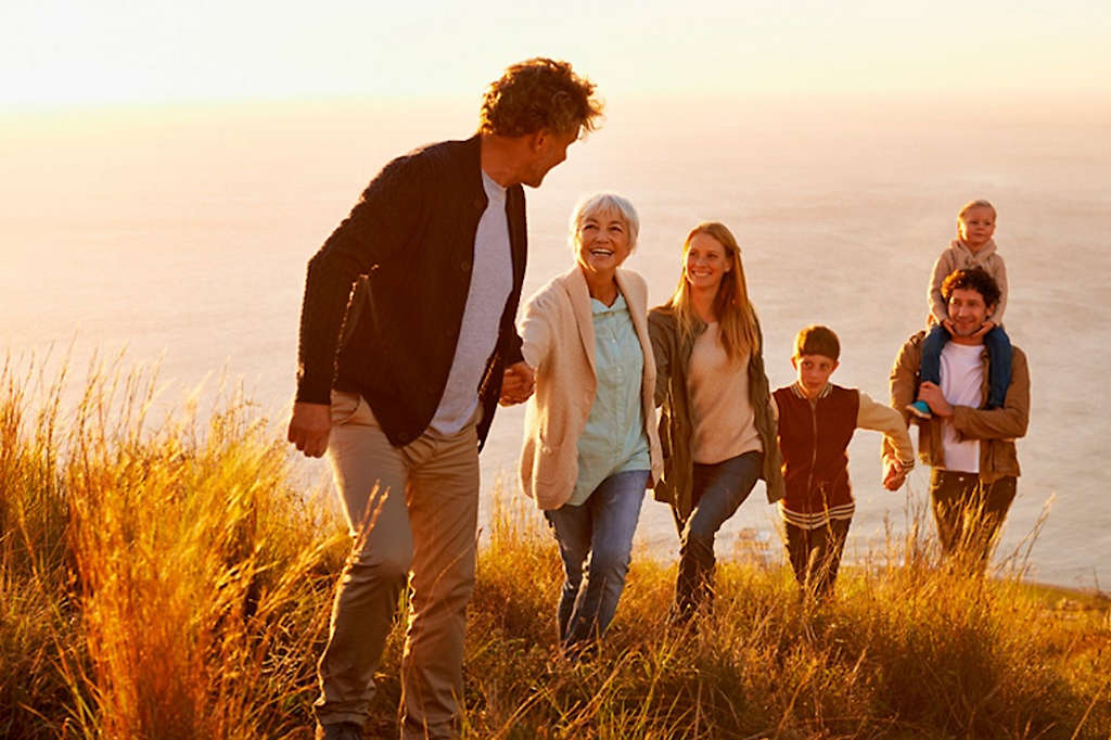 Happy family hiking on the coast