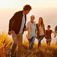 Happy family hiking on the coast