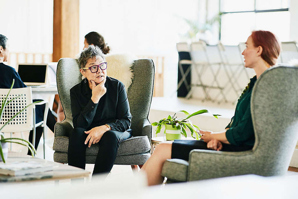 Two people sitting and talking