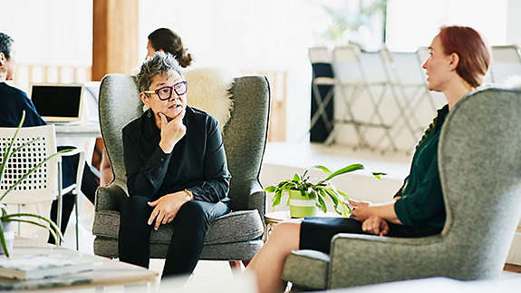 Two people sitting and talking