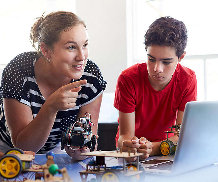 Teacher at table with students