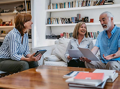 Mature couple at home speaking with agent