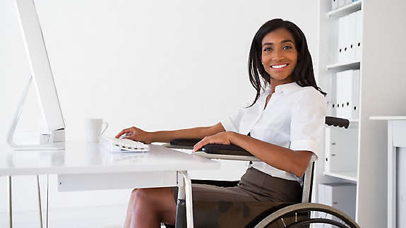 A woman smiling in a wheelchair
