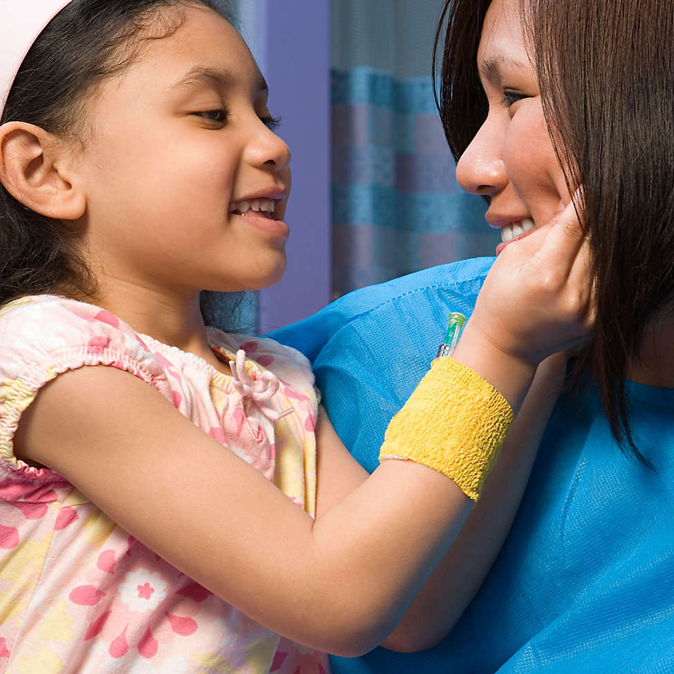 Nurse holding a smiling child