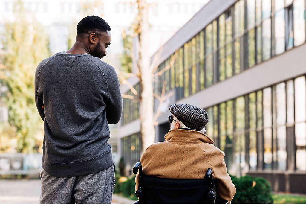 A young man speaking to an elderly friend about his retirement goals.