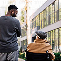 A young man speaking to an elderly friend about his retirement goals.