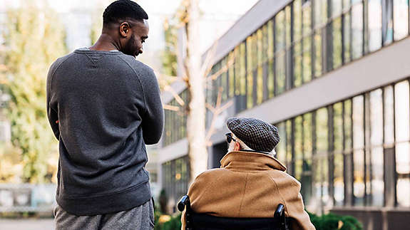 A young man speaking to an elderly friend about his retirement goals.