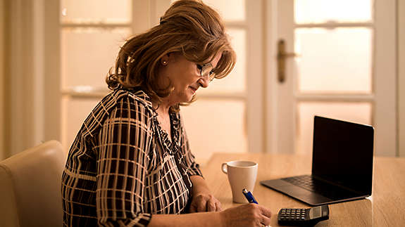 Woman at home with laptop