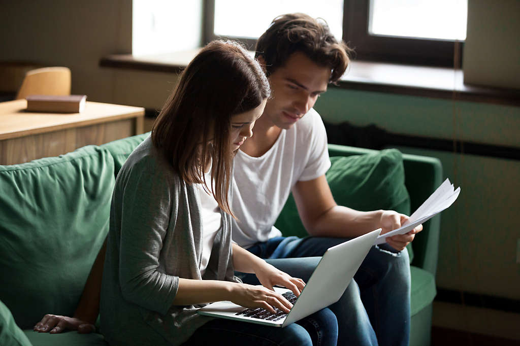 Couple at home looking at paperwork