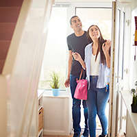 Young couple entering new home
