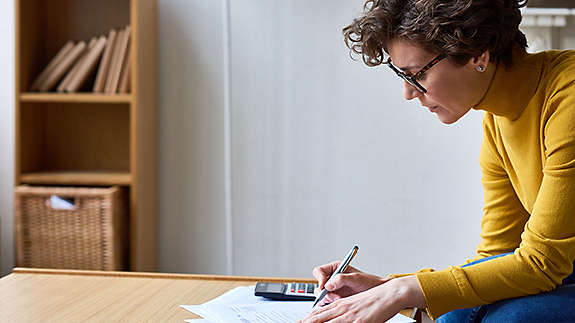 Woman sitting and handling paperwork