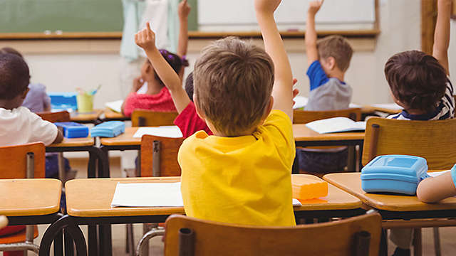 Teacher and student in front of class