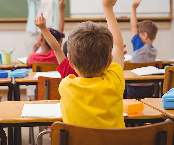 School children raising hands