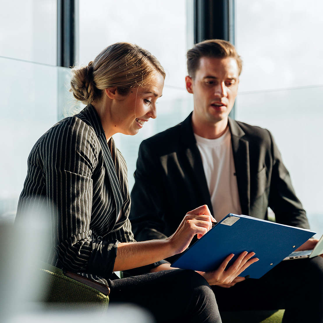 Woman and man looking at clipboard