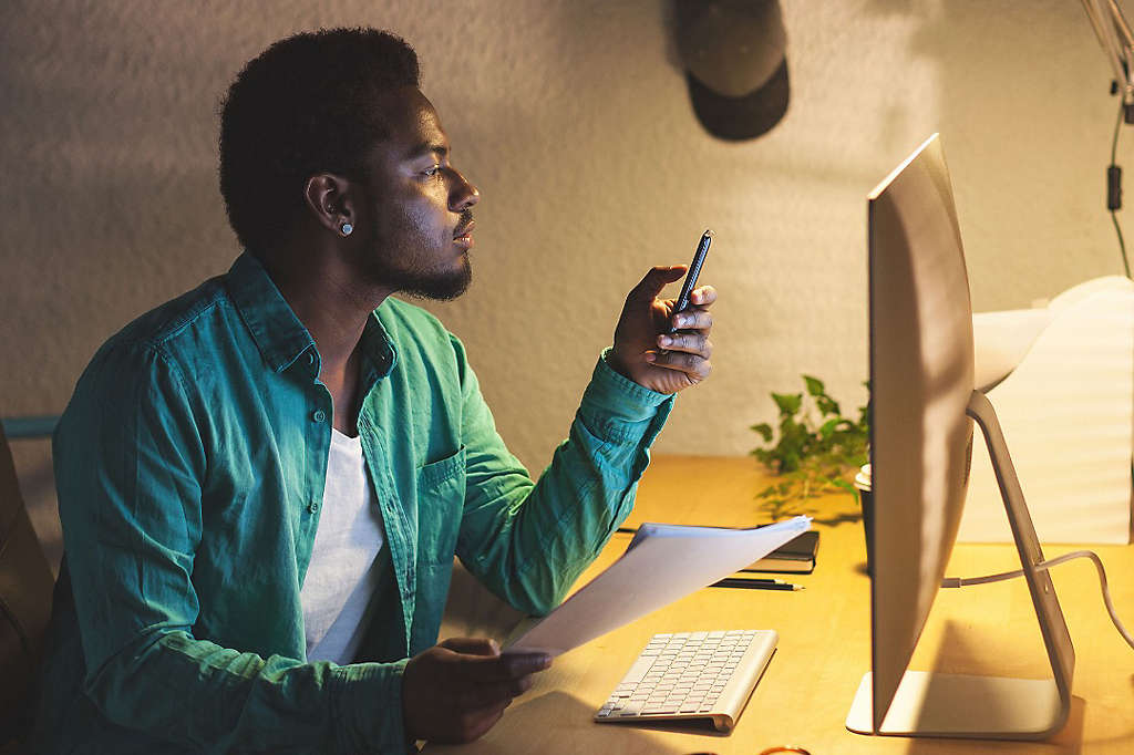 Relaxed Creative Black Businessman Using Mobile Phone