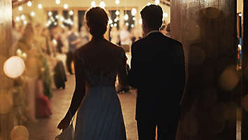 Married couple walking into their reception