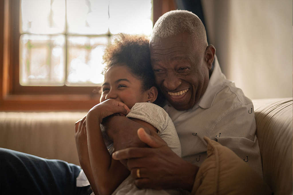 Grandfather hugging his granddaughter