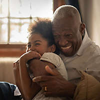 Grandfather hugging his granddaughter