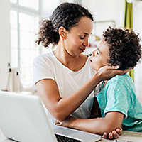 Mom and son working on the computer.