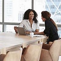 Woman in office chatting with financial services professional about portfolio diversification