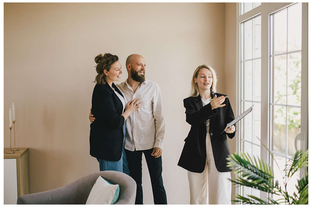 A couple with a realtor looking at houses